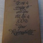 moto laser engraved onto brown leather book